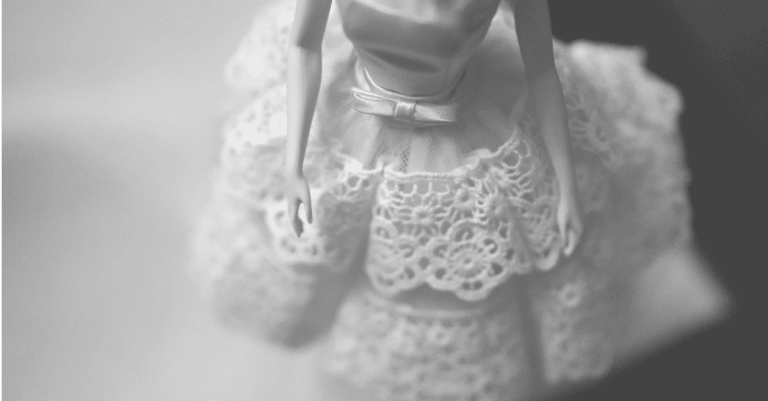Here we have a close-up of a doll's dress in black and white, launching our discussion of fake Barbie dolls.