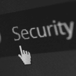 This image of a cursor moving over the word "security" on a browser highlights this topic's domain cybersecurity discussion.