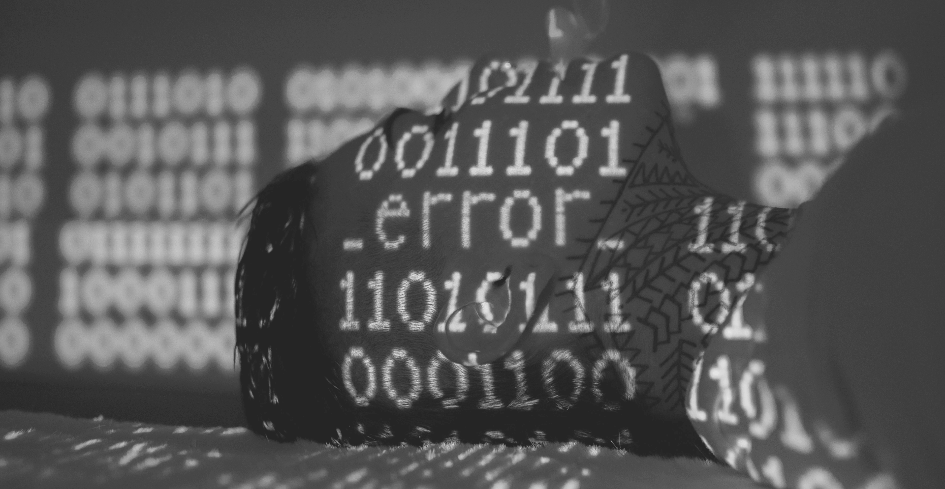This image of code lines projected on someone's face illustrates our discussion topic: the differences between SSL and TLS.