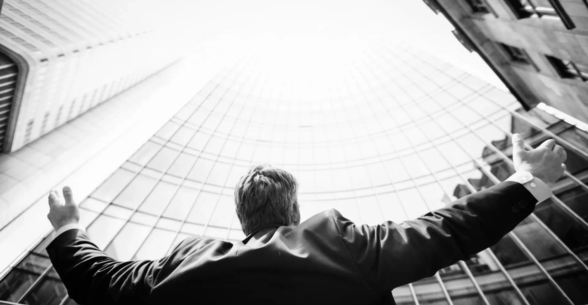 This image of a suited man with his arms outstretched illustrates our discussion topic about CEO fraud.