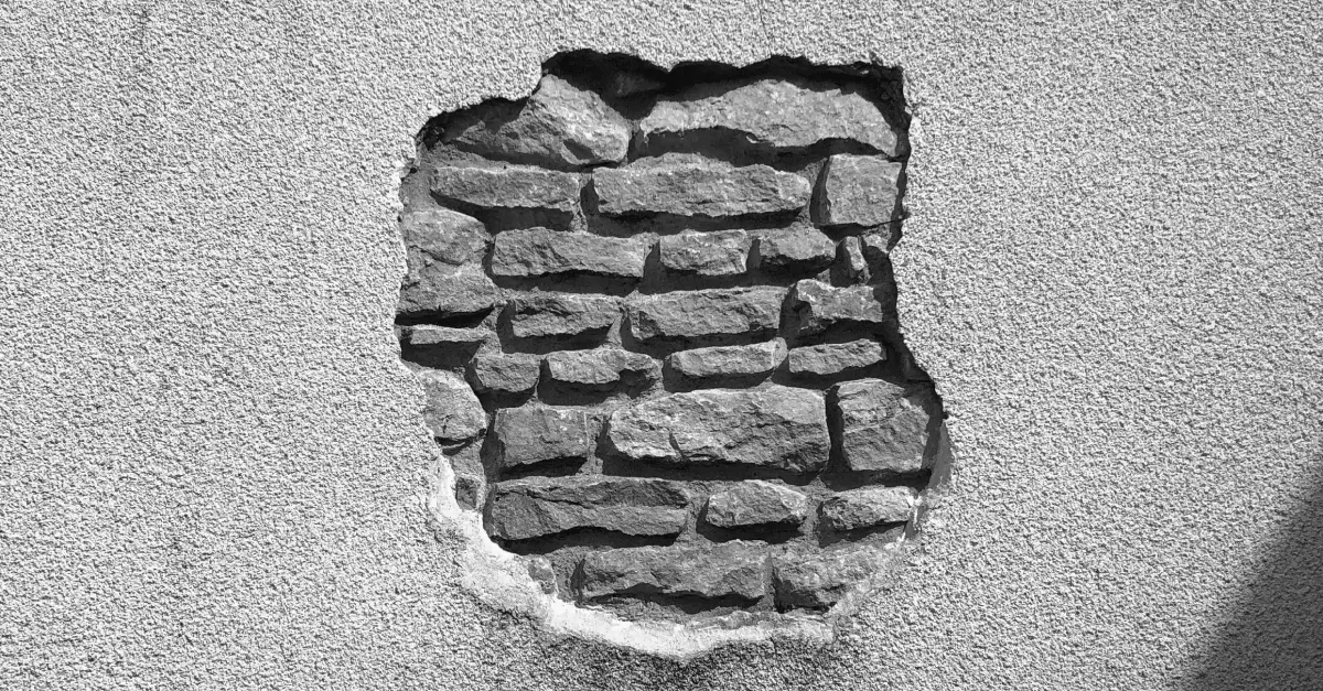 This image of a wall with a crack in it that exposes the brick illustrates our discussion topic: Gaps in domain portfolios, and how to fill them.